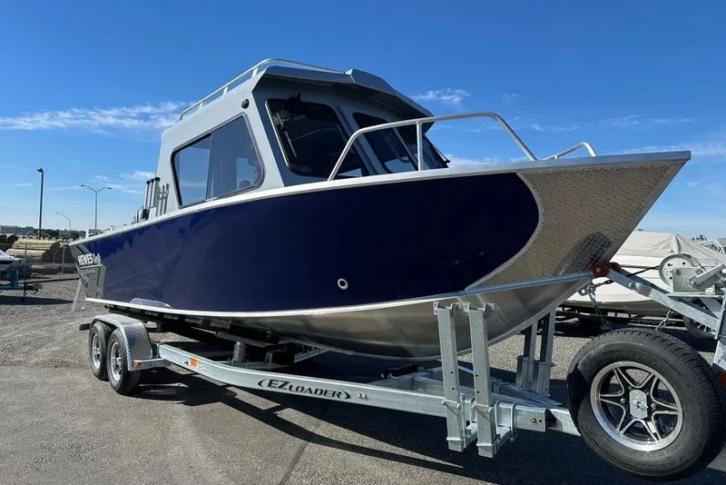 The Image of 2026 Hewescraft 240 Ocean Pro ET boat on trailer under clear blue sky. - 1