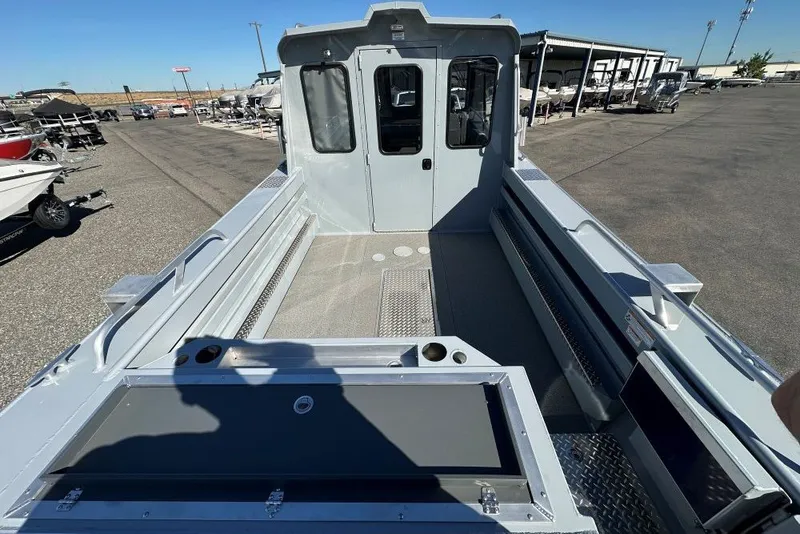 Slide: The Image of 2026 Hewescraft 240 Ocean Pro ET boat, spacious deck, parked in a marina. - 4