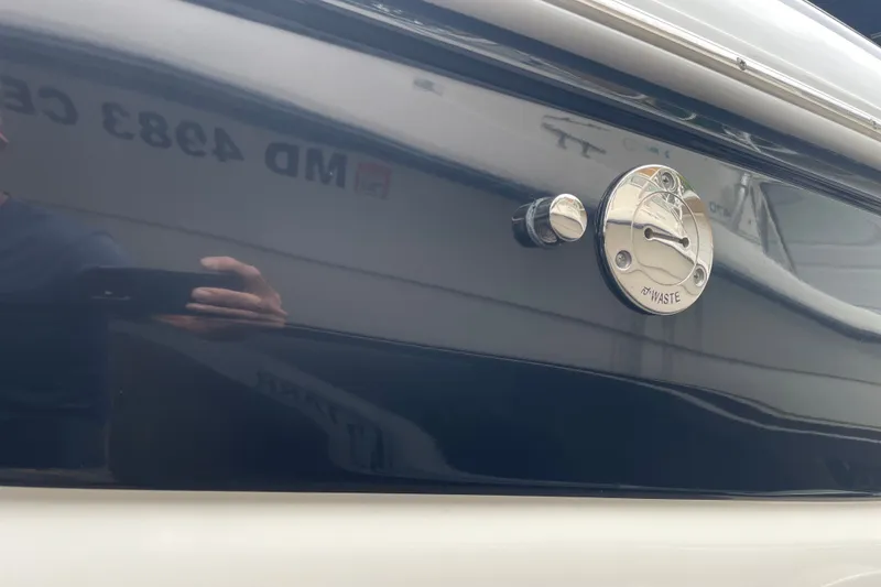 Slide: The Image of 2017 Crownline 285 SS boat waste outlet with reflective surface. - 35