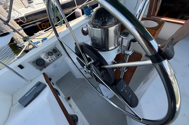 Slide: The Image of Steering wheel and controls of a 1987 Catalina 34 sailboat at a marina. - 17