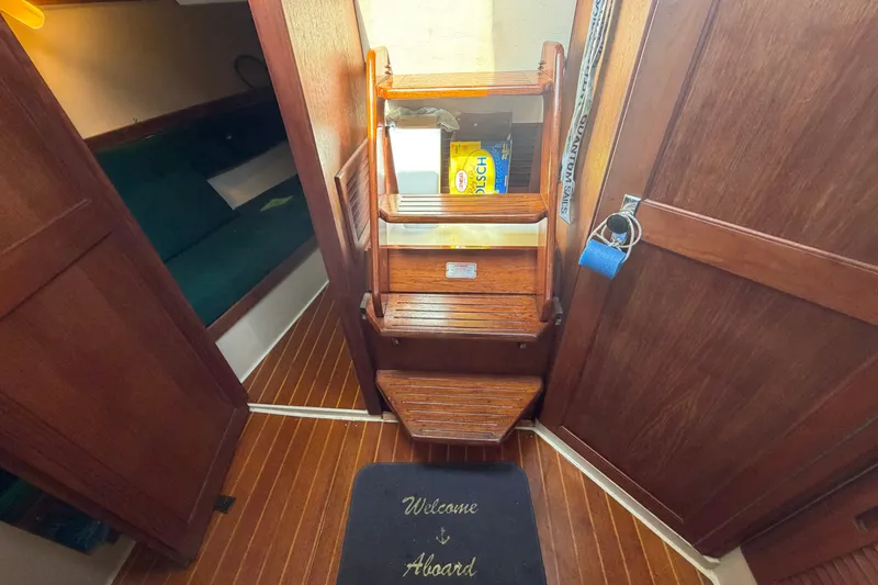 Slide: The Image of Interior of 1987 Catalina 34 sailboat with wooden steps and cozy cabin. - 26