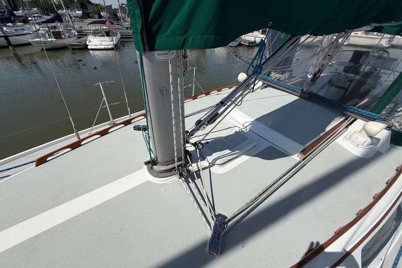 Slide: The Image of 1987 Catalina 34 sailboat deck with rigging, docked in a marina. - 10