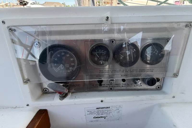 Slide: The Image of Control panel of a 1987 Catalina 34 yacht with gauges and safety instructions. - 20