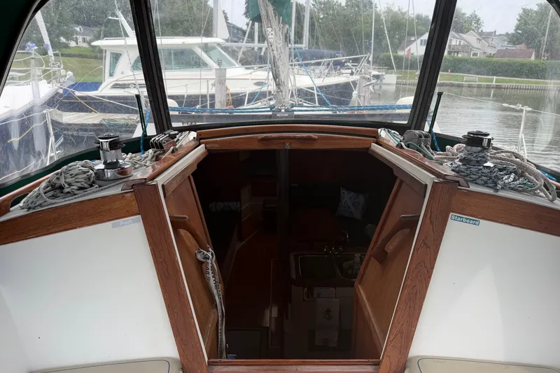 Slide: The Image of Cockpit view of a 1987 Catalina 34 sailboat docked at a marina. - 24