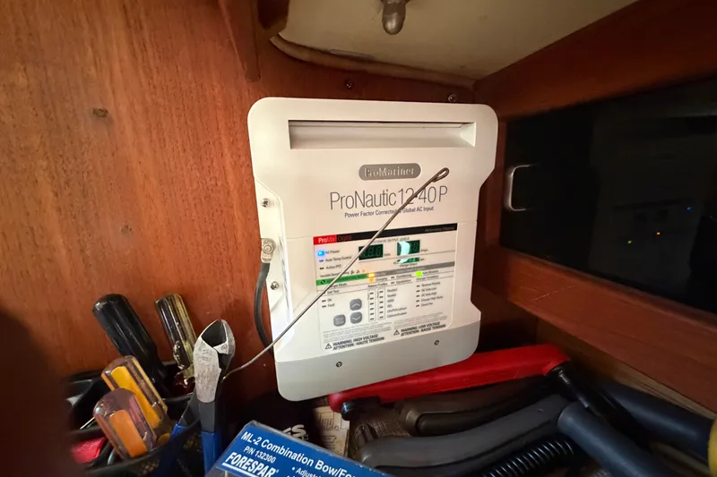 Slide: The Image of ProNautic 1240P charger inside 1987 Catalina 34 boat, surrounded by tools and equipment. - 42