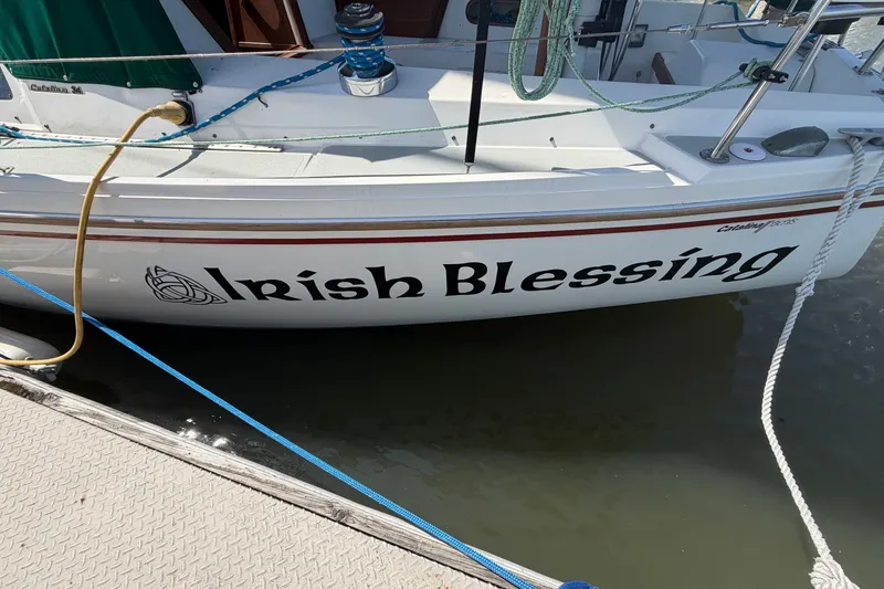 Slide: The Image of 1987 Catalina 34 sailboat named "Irish Blessing" docked at a marina. - 5