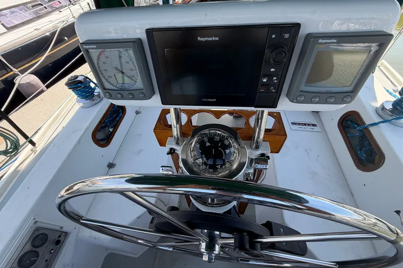 Slide: The Image of Cockpit of 1987 Catalina 34 sailboat with navigation instruments and steering wheel. - 16