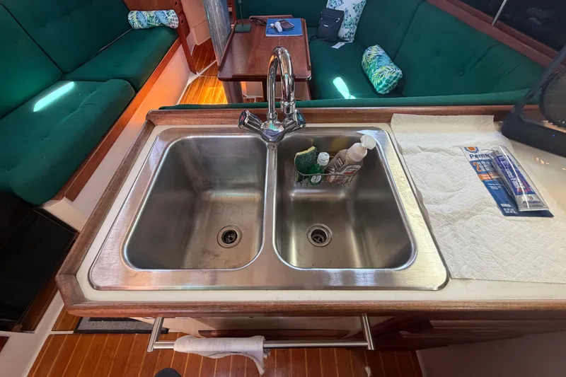 Slide: The Image of Interior of a 1987 Catalina 34 sailboat featuring a dual stainless steel sink. - 36