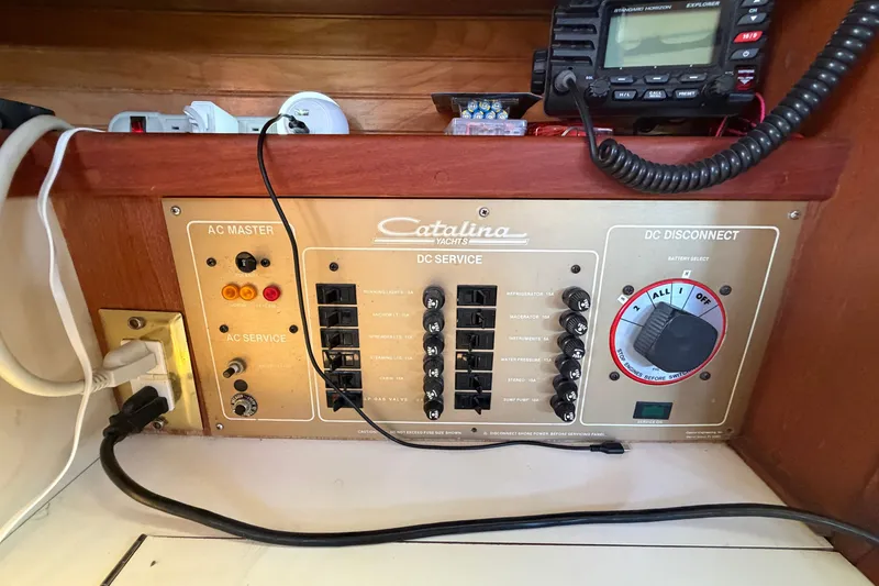 Slide: The Image of Electrical panel of a 1987 Catalina 34 yacht with AC and DC controls. - 41