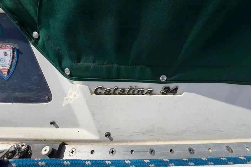 Slide: The Image of 1987 Catalina 34 sailboat with green cover and visible emblem. - 22