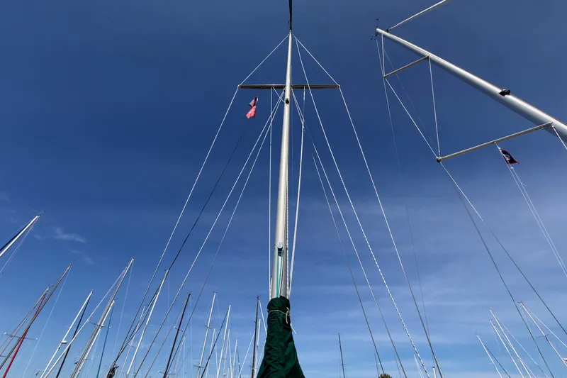 Slide: The Image of Masts of a 1987 Catalina 34 sailboat against a clear blue sky. - 23