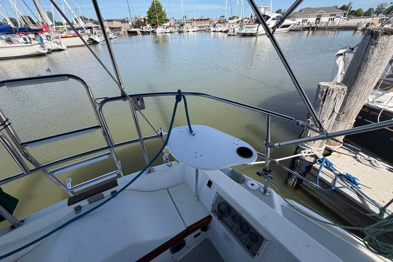 Slide: The Image of Cockpit view of a 1987 Catalina 34 sailboat docked in a marina. - 13