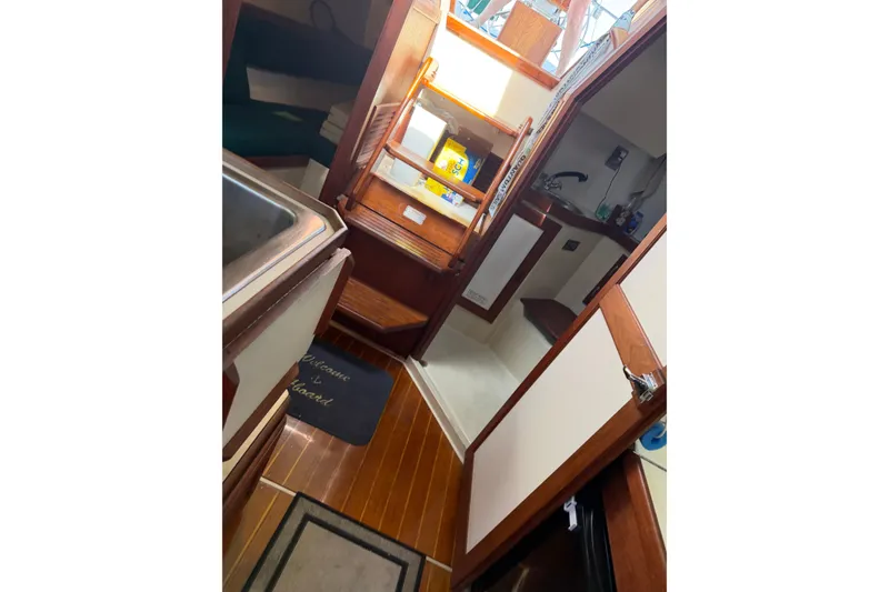 Slide: The Image of Interior of a 1987 Catalina 34 sailboat with wooden finishes and compact layout. - 38
