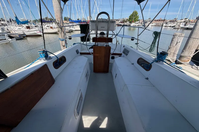 Slide: The Image of Cockpit of a 1987 Catalina 34 sailboat docked at a marina. - 14