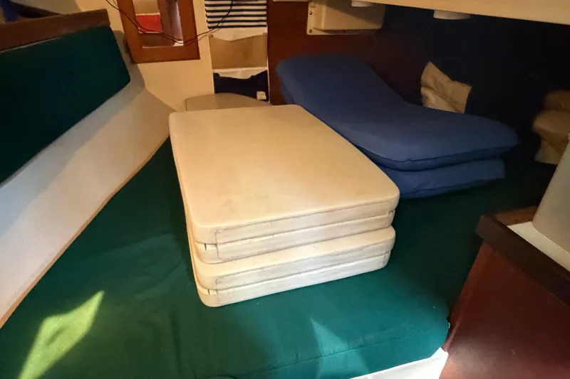Slide: The Image of Interior cabin of a 1987 Catalina 34 sailboat with stacked cushions. - 28