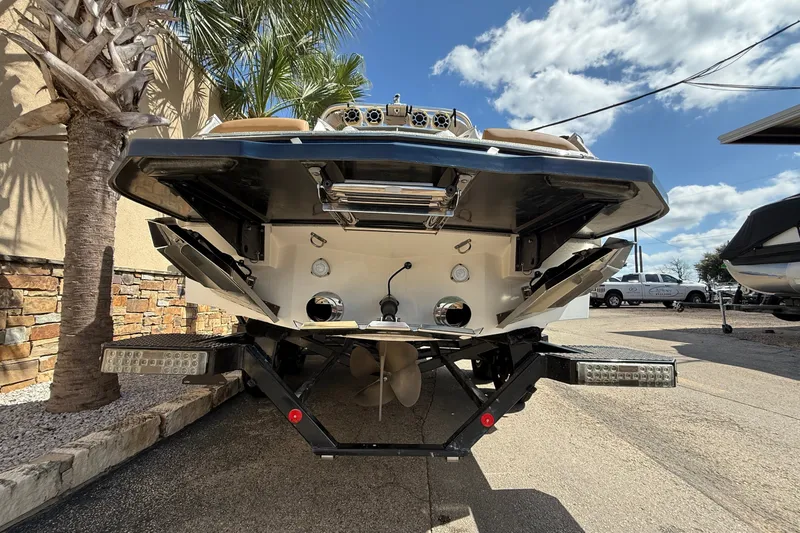 Slide: The Image of Rear view of a 2020 MasterCraft X24 boat on a trailer under a sunny sky. - 4