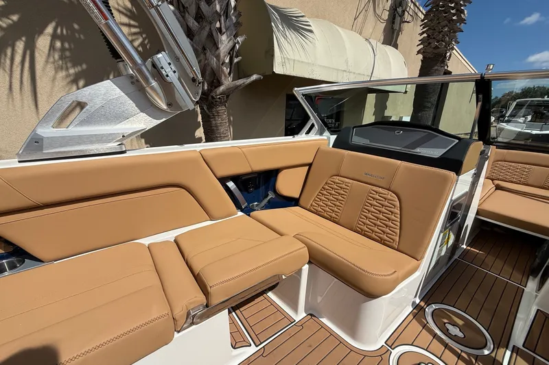 Slide: The Image of 2020 MasterCraft X24 boat interior with tan leather seating and teak flooring. - 6