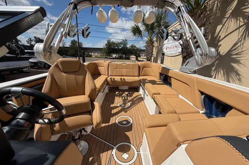 Slide: The Image of 2020 MasterCraft X24 boat interior with tan leather seating and modern design. - 10