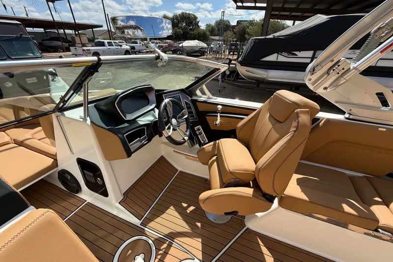 Slide: The Image of 2020 MasterCraft X24 boat interior with tan leather seats and modern dashboard. - 7