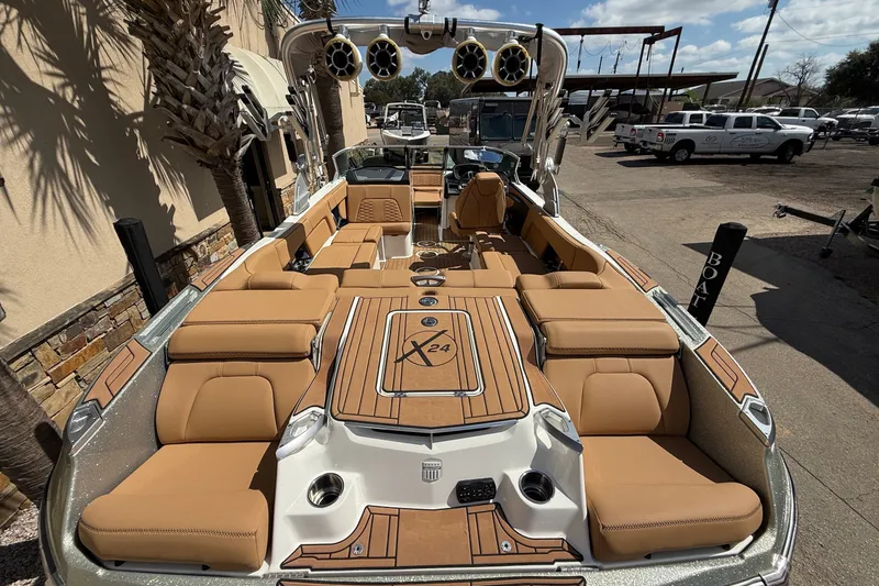 Slide: The Image of 2020 MasterCraft X24 boat with tan seating and sleek design, parked outdoors. - 5