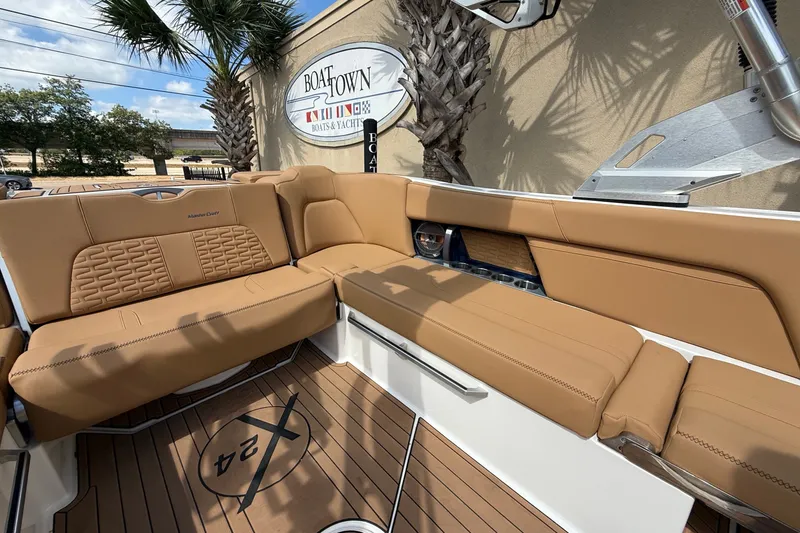 Slide: The Image of 2020 MasterCraft X24 boat interior with tan seating and teak flooring at Boat Town. - 12
