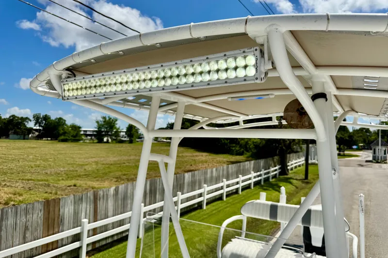 Slide: The Image of 2017 Shallow Sport 25 X3 boat with LED light bar on T-top, sunny day background. - 18