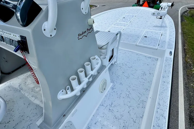 Slide: The Image of 2017 Shallow Sport 25 X3 boat deck with rod holders and control panel. - 14