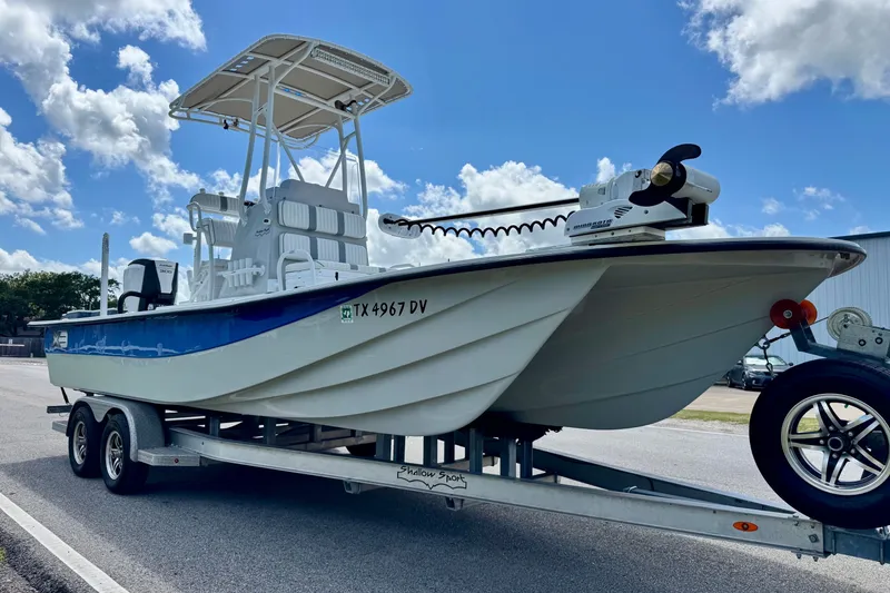 Slide: The Image of 2017 Shallow Sport 25 X3 boat on trailer under blue sky. - 5