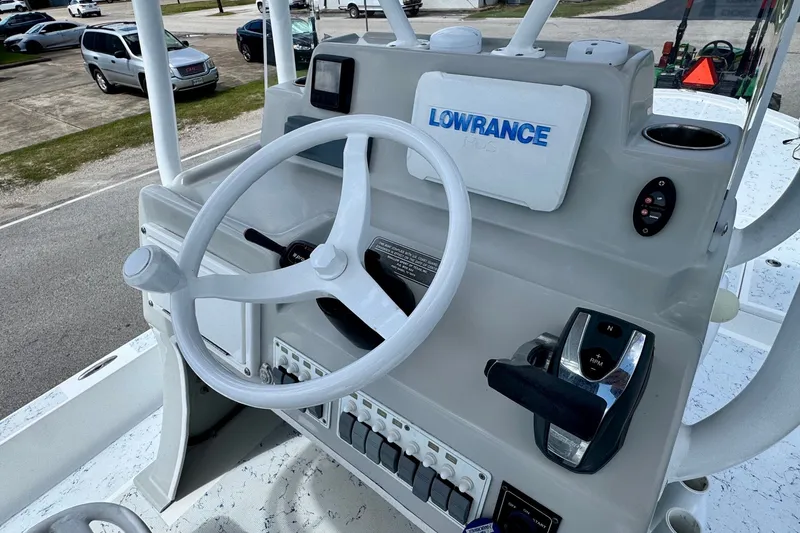 Slide: The Image of 2017 Shallow Sport 25 X3 boat console with steering wheel and Lowrance navigation system. - 16