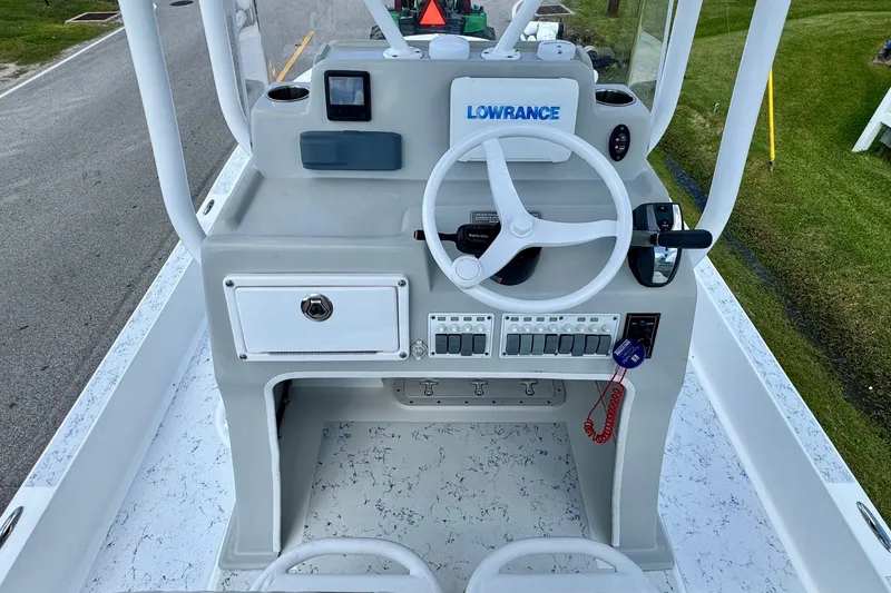 Slide: The Image of 2017 Shallow Sport 25 X3 boat console with steering wheel and Lowrance system. - 10