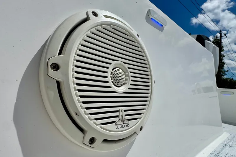 Slide: The Image of Close-up of JL Audio speaker on 2017 Shallow Sport 25 X3 boat under blue sky. - 17