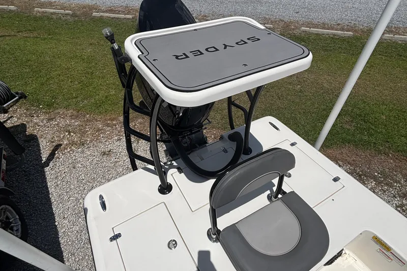 Slide: The Image of 2024 Spyder FX19 Vapor boat with elevated platform and seating, displayed outdoors. - 8