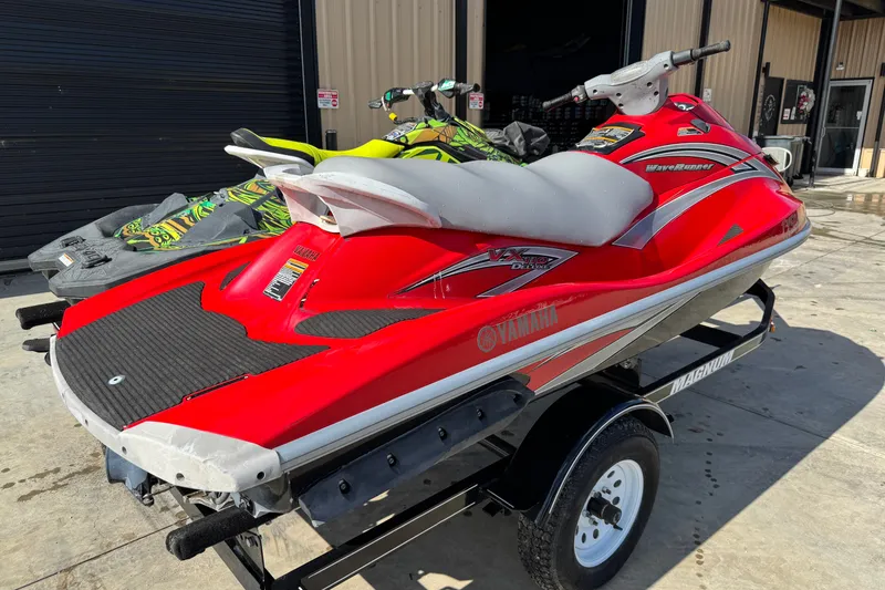 Slide: The Image of 2006 Yamaha WaveRunner VX110 Deluxe in red on a trailer, parked outdoors. - 3