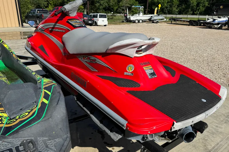 Slide: The Image of 2006 Yamaha WaveRunner VX110 Deluxe in vibrant red, parked outdoors. - 7