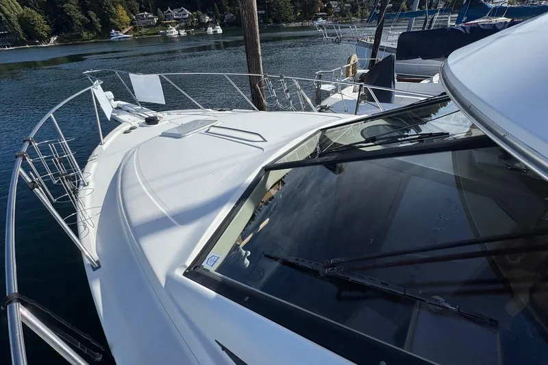 Slide: The Image of 1998 Bayliner 3388 Command Bridge Motoryacht docked in a scenic marina. - 40