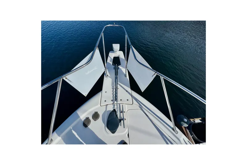 Slide: The Image of 1998 Bayliner 3388 Command Bridge Motoryacht bow view on calm water. - 8