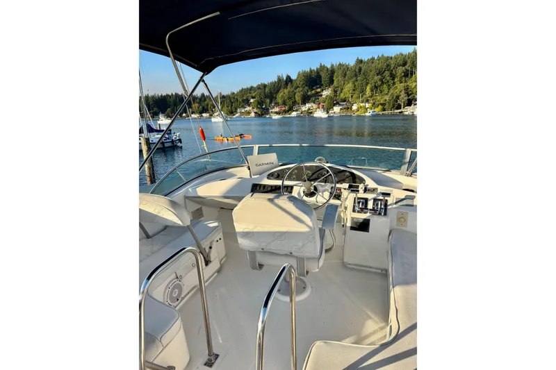 Slide: The Image of 1998 Bayliner 3388 Command Bridge Motoryacht interior with scenic waterfront view. - 10