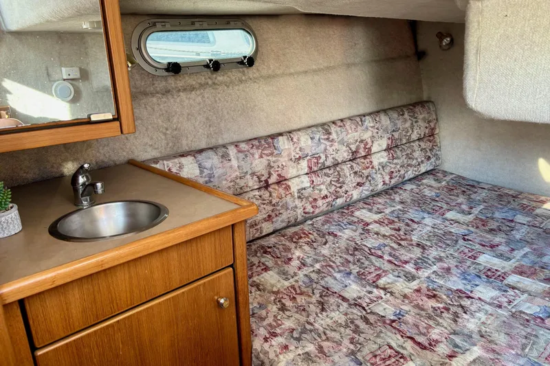 Slide: The Image of 1998 Bayliner 3388 Command Bridge Motoryacht interior with sink and patterned bedding. - 34