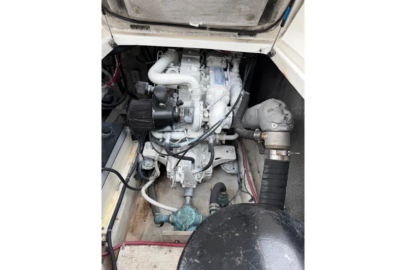 Slide: The Image of Engine compartment of 1998 Bayliner 3388 Command Bridge Motoryacht, showcasing mechanical components. - 36