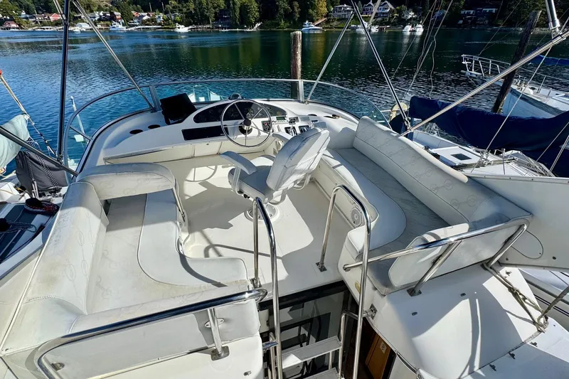 Slide: The Image of 1998 Bayliner 3388 Command Bridge Motoryacht with spacious seating and scenic waterfront view. - 12