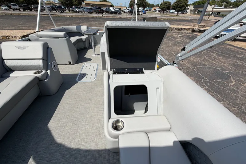 Slide: The Image of 2025 Bennington 22 L Quad Bench pontoon boat interior with open storage compartment. - 37