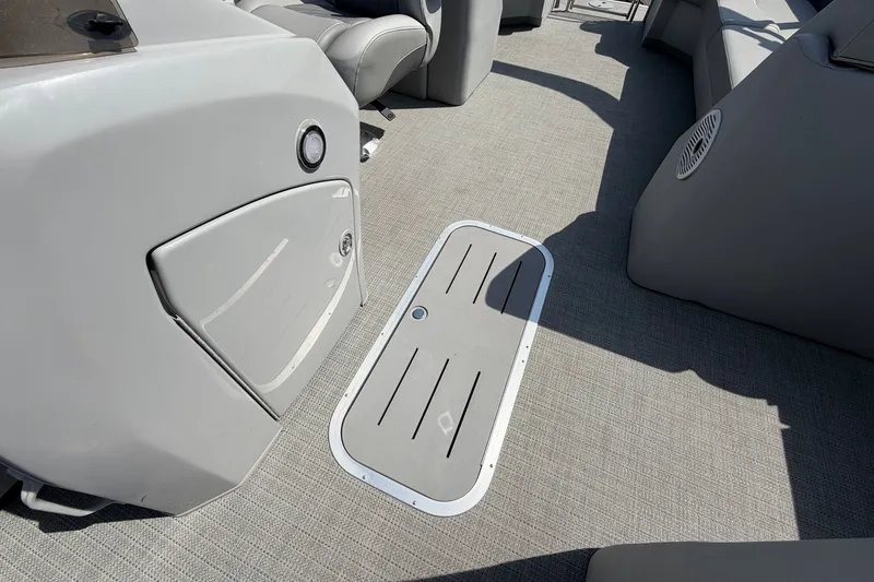 Slide: The Image of Interior of 2025 Bennington 22 L Quad Bench boat, featuring sleek gray flooring and seating. - 41