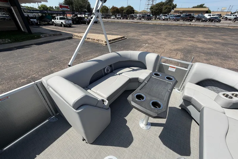 Slide: The Image of 2025 Bennington 22 L Quad Bench pontoon boat with gray seating and table. - 15