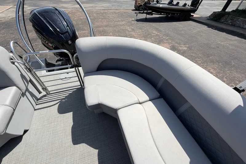 Slide: The Image of 2025 Bennington 22 L Quad Bench boat interior with plush seating and motor view. - 30
