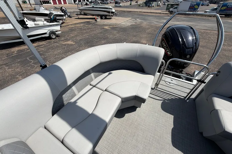 Slide: The Image of 2025 Bennington 22 L Quad Bench boat interior with plush seating and powerful outboard motor. - 32