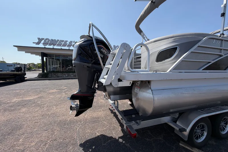 Slide: The Image of 2025 Bennington 22 L Quad Bench pontoon boat with Yamaha engine at dealership. - 11