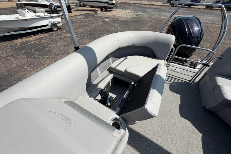 Slide: The Image of 2025 Bennington 22 L Quad Bench boat interior with open storage compartment and motor view. - 35