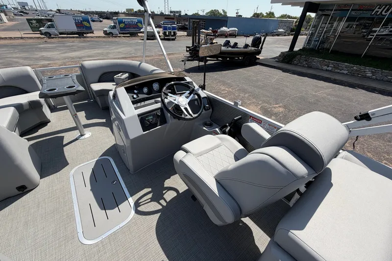 Slide: The Image of 2025 Bennington 22 L Quad Bench pontoon boat interior with steering console and seating. - 38