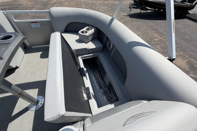 Slide: The Image of 2025 Bennington 22 L Quad Bench with open storage compartment and cup holders. - 20