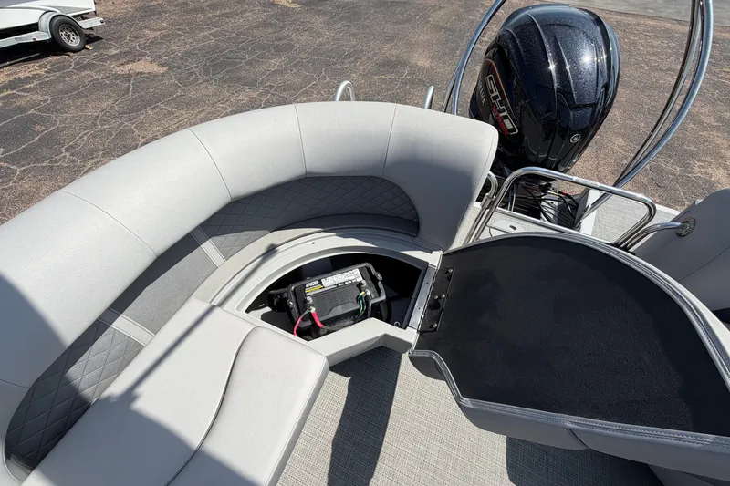 Slide: The Image of 2025 Bennington 22 L Quad Bench boat with open storage compartment and motor. - 33